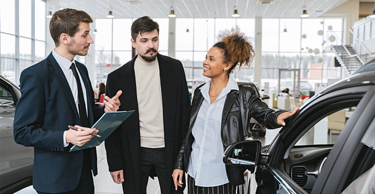 man selling car in showroom