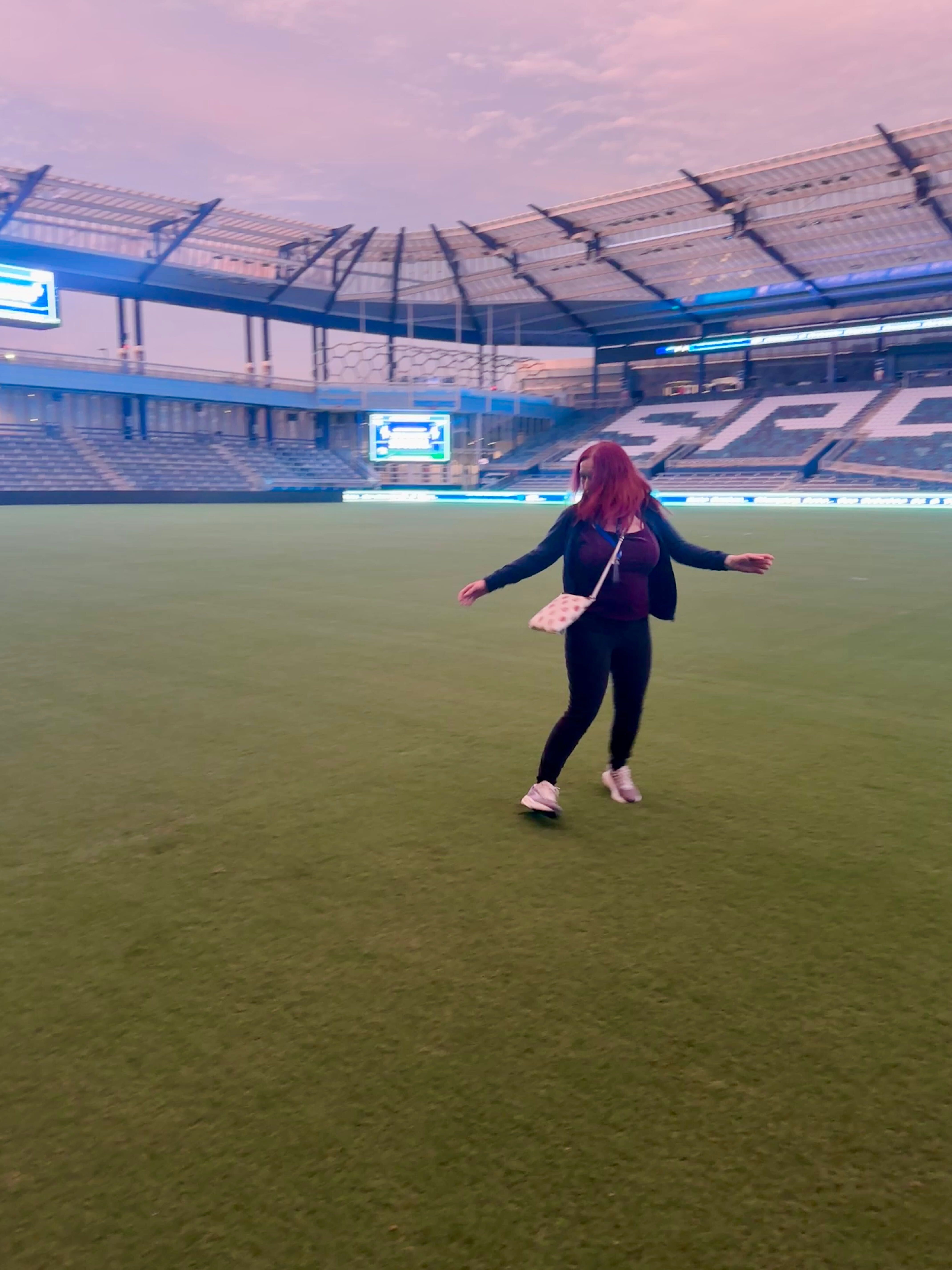 Tracy Camacho spinning on the pitch at Sporting KC Park