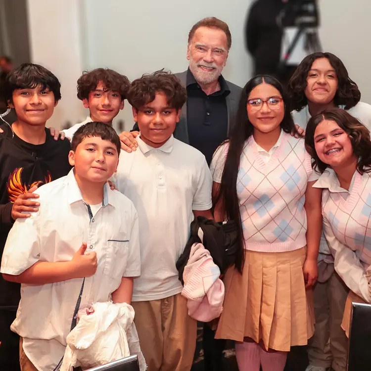 Arnold Schwarzenegger standing with kids