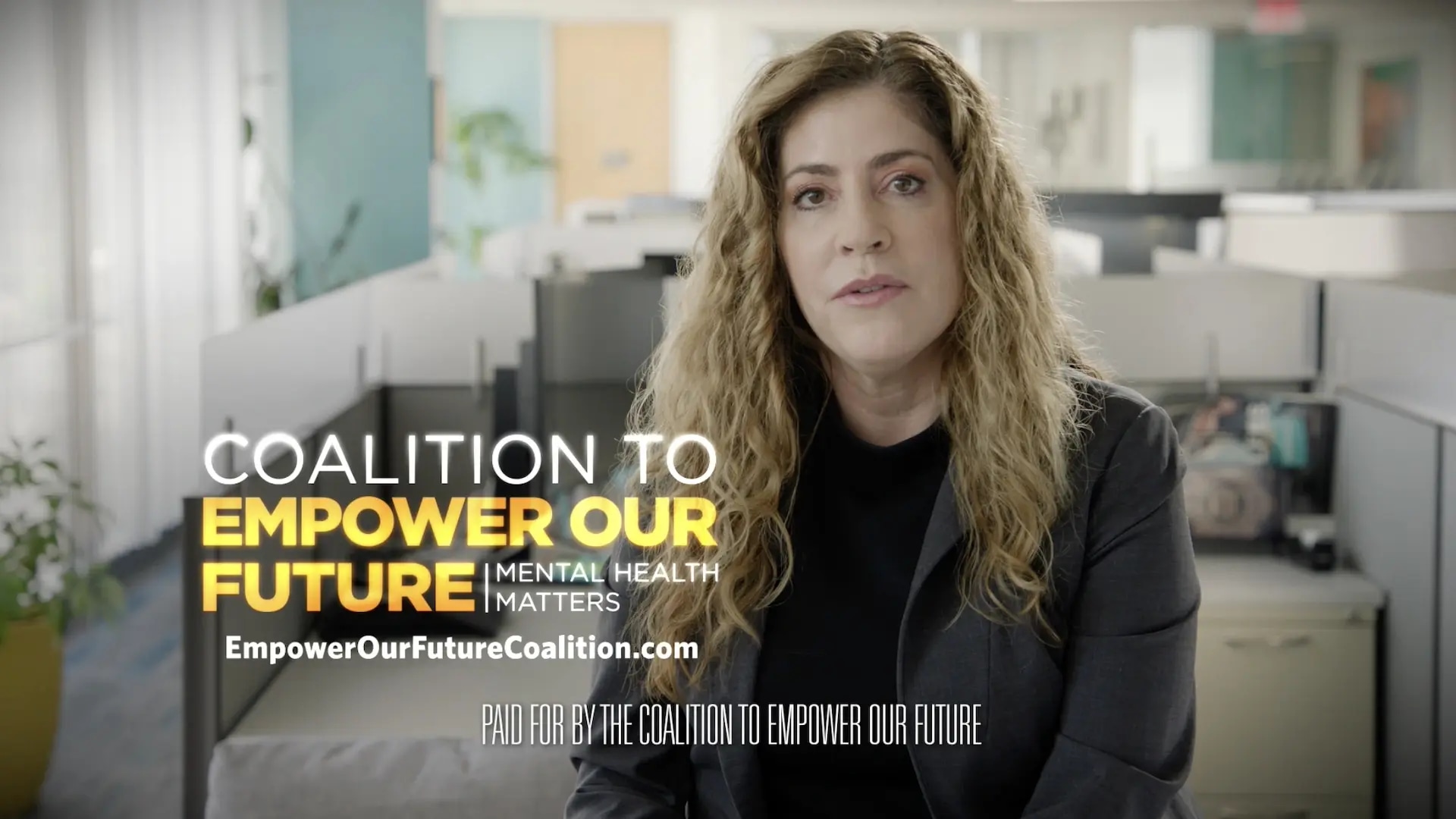 Woman with black shirt sitting in front of camera