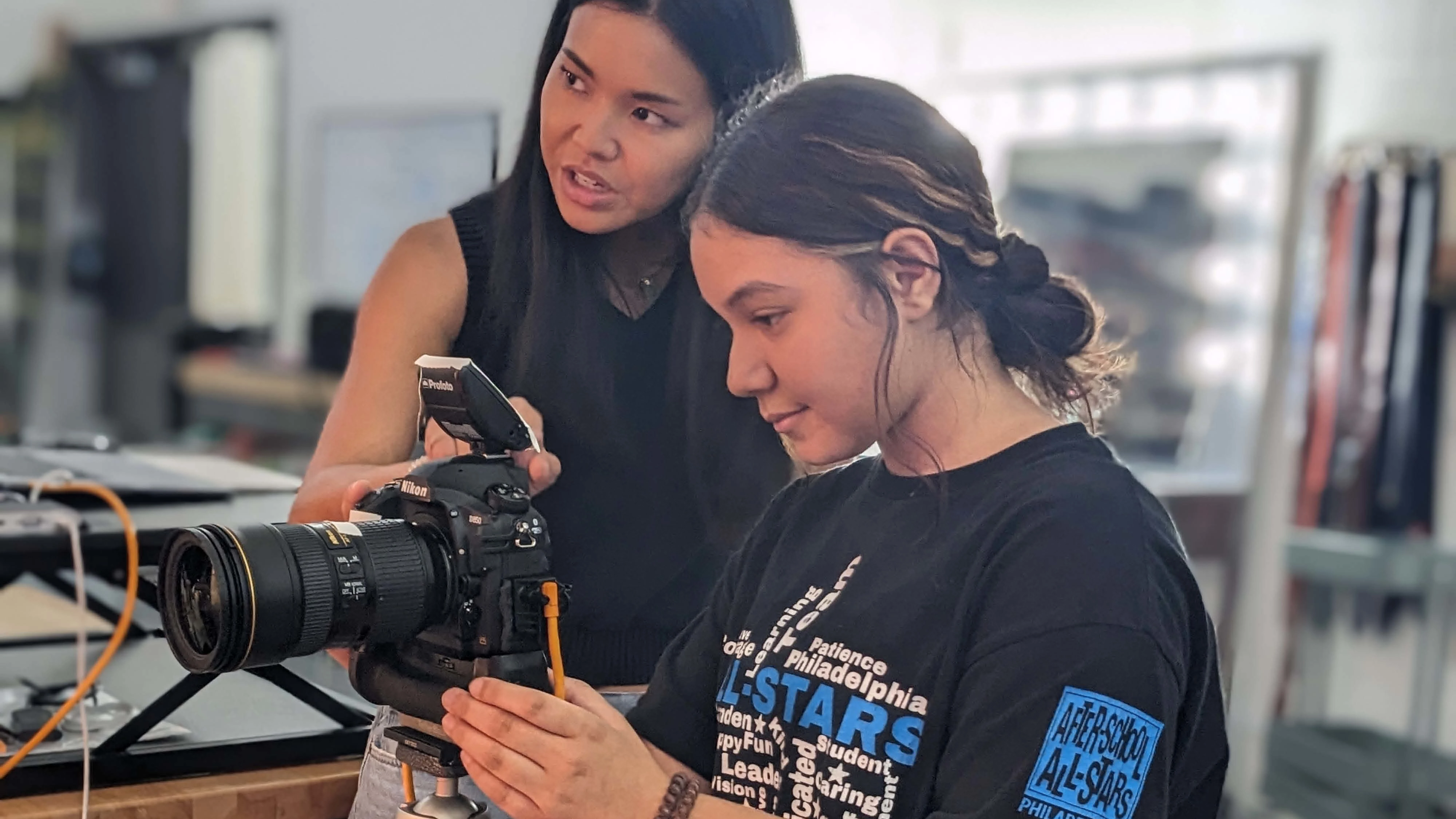 Photographer teaches student on after-school field trip to URBN campus