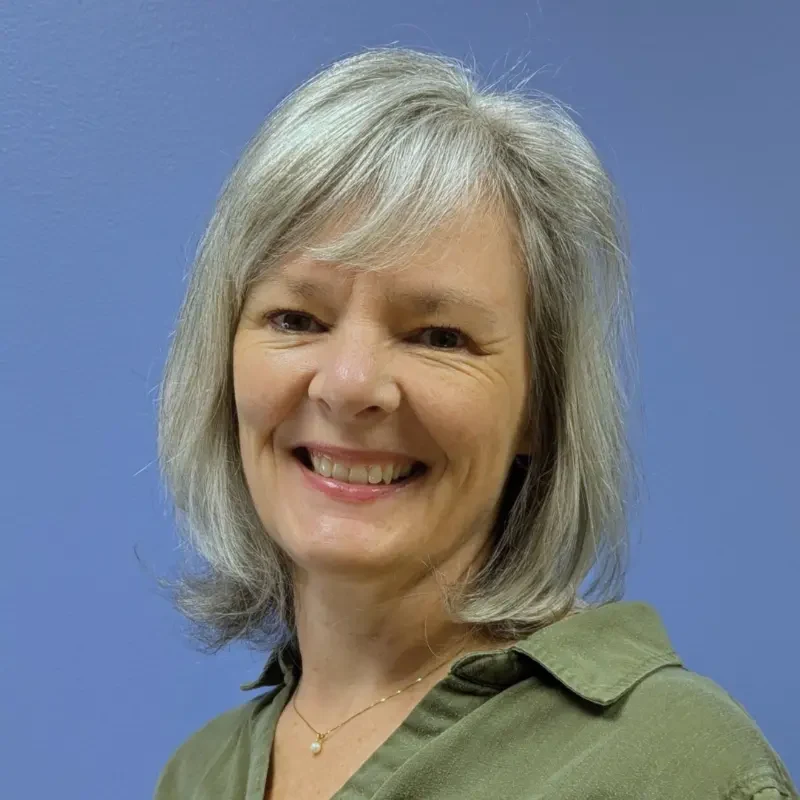 Woman wearing green shirt smiling