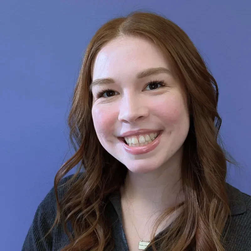 A woman in a black shirt smiles