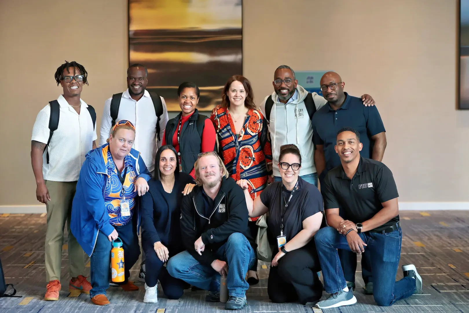 A group of After-School All-Stars staff members huddle together for a photo