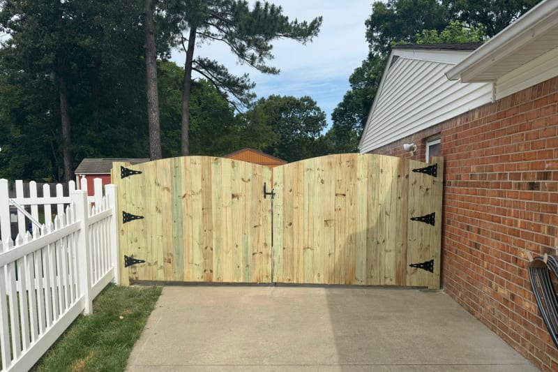 Treated arch top privacy fence with welded steel frame gate installed in Kempsville VA by Kempsville Fence — photo 2