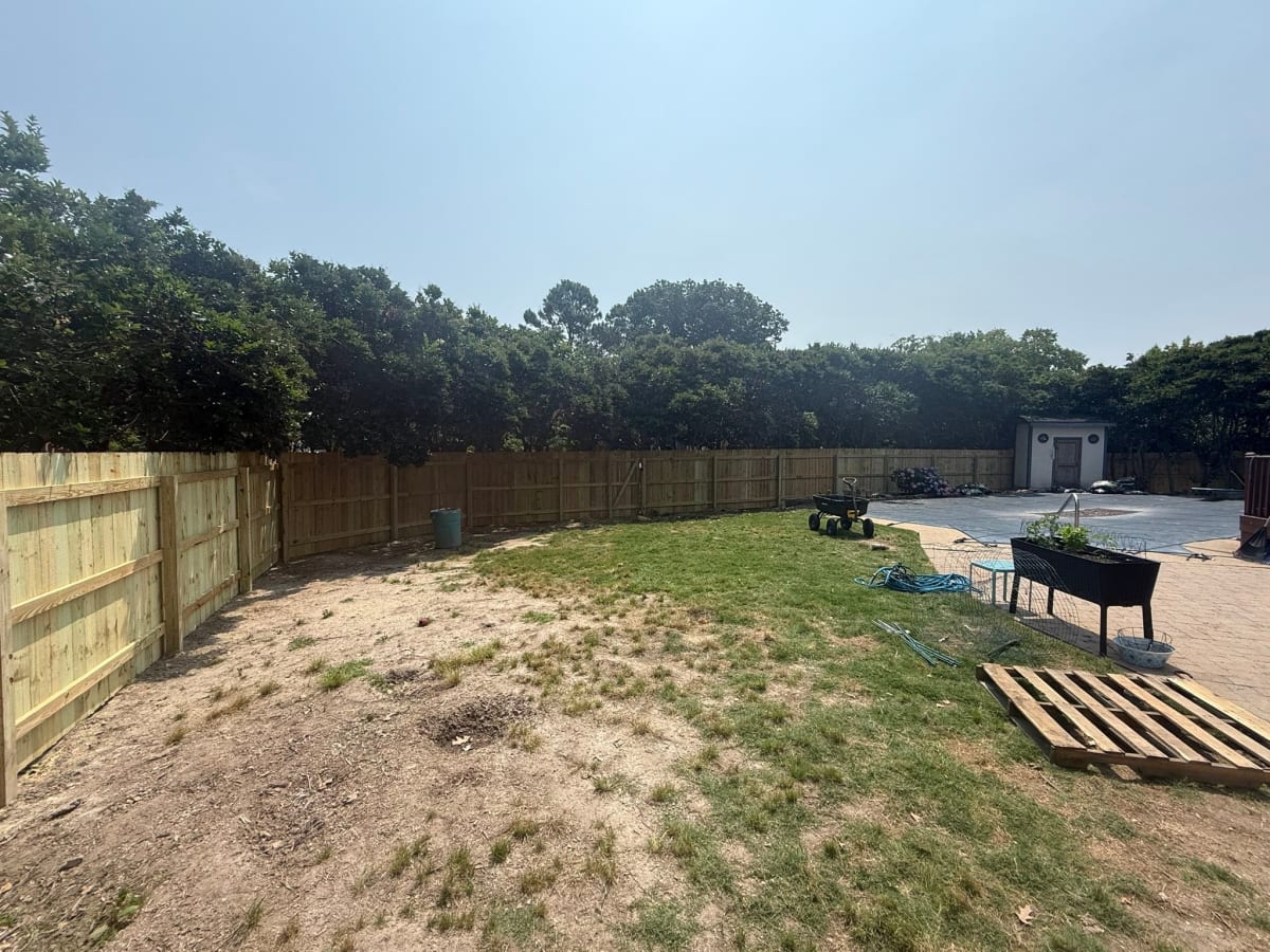 Wood privacy fence installed between mature trees in Virginia Beach VA by Kempsville Fence