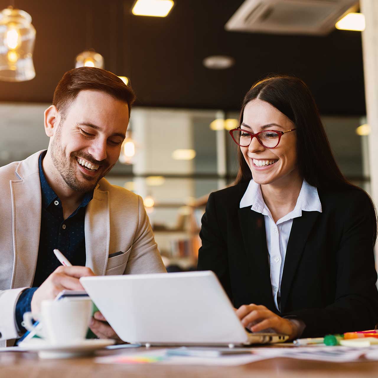 Two business people talking about marketing at a coffee shop