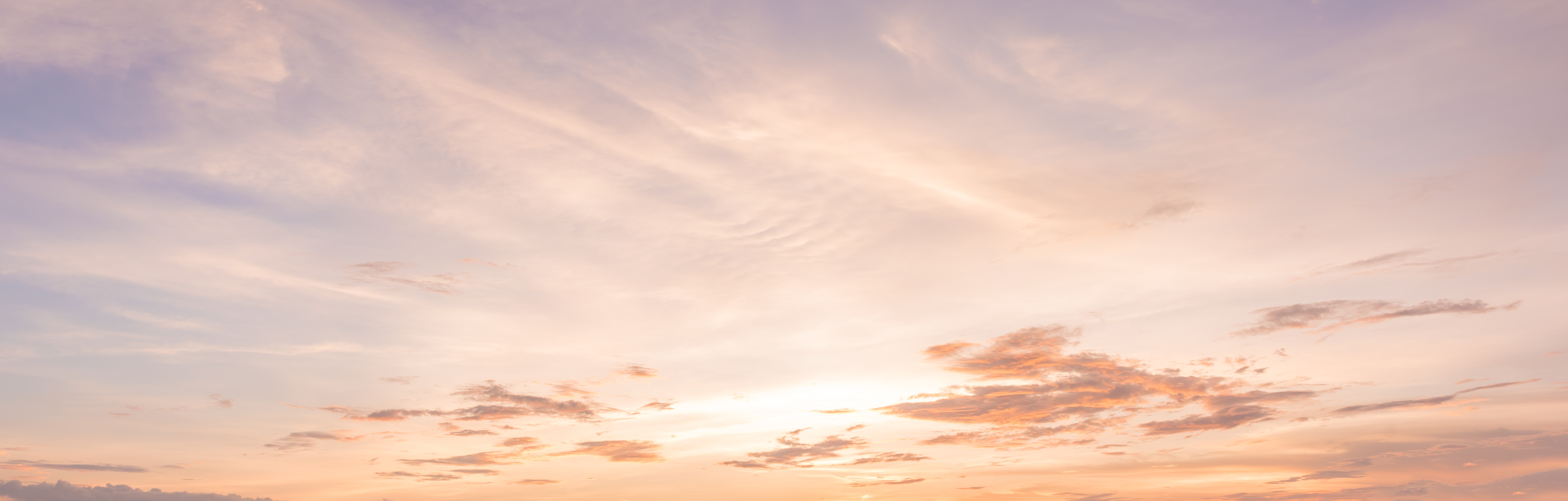 Pink sky with pale clouds at sunset