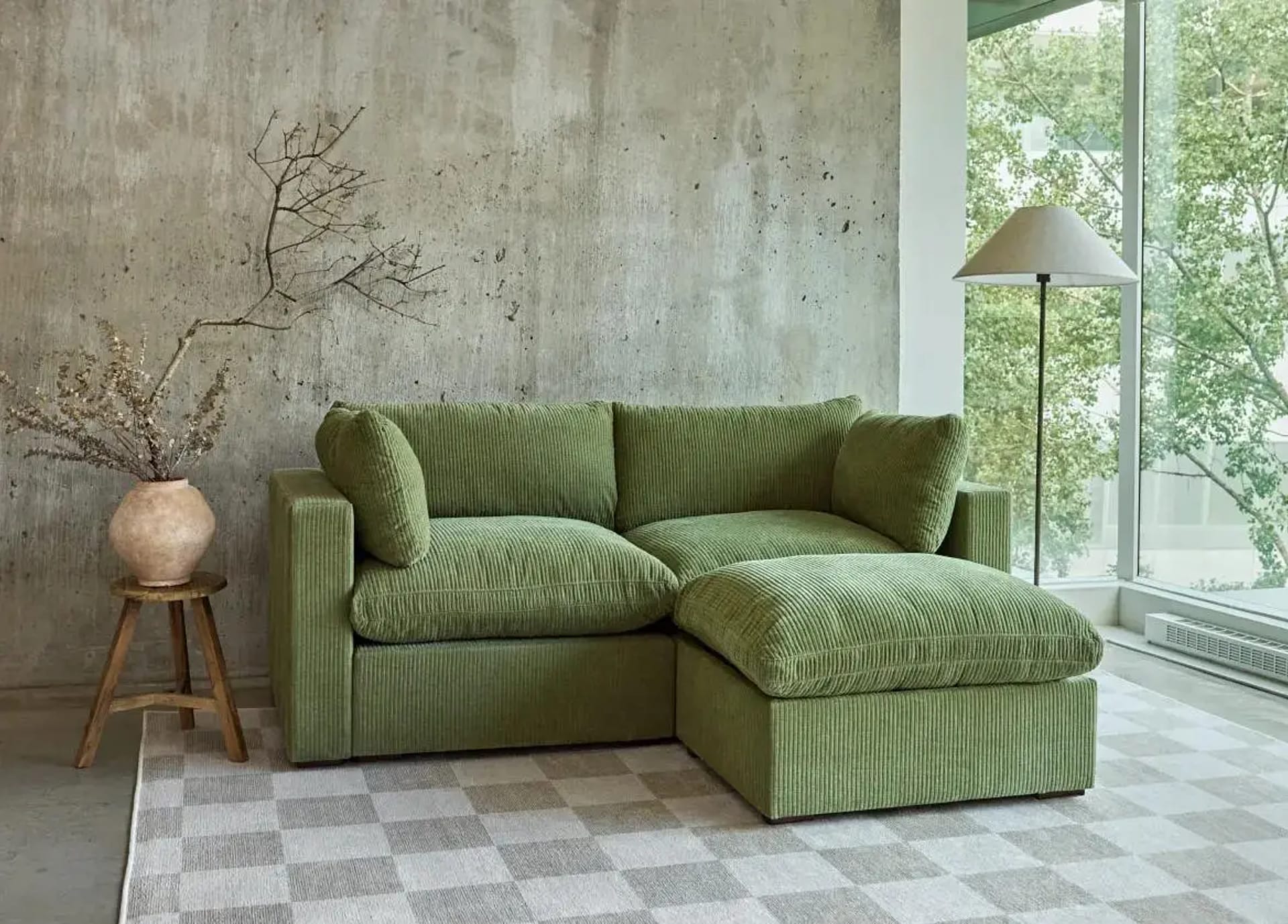 Green love seat sofa with ottoman.