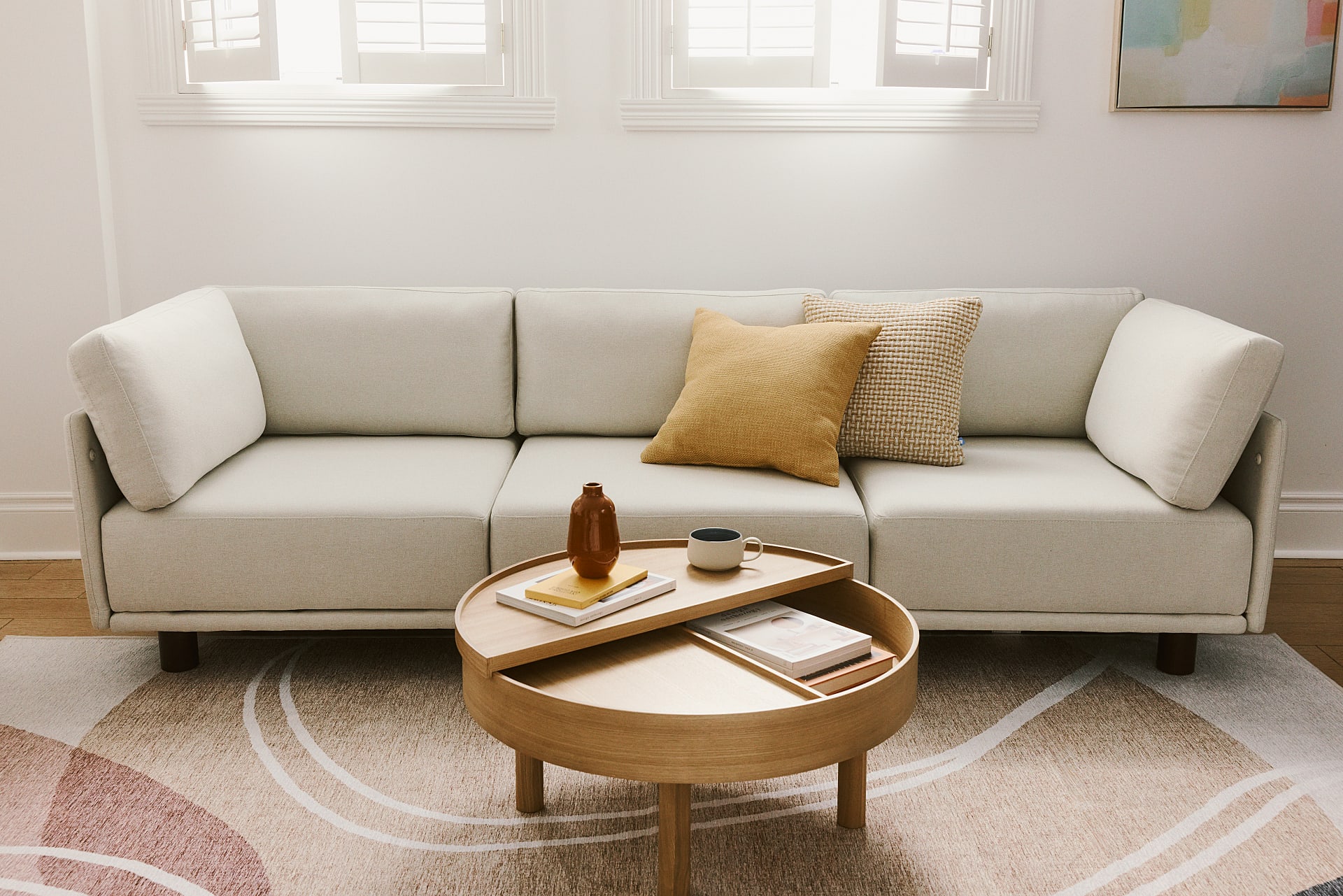 Picture of white three seater sofa with wood legs.