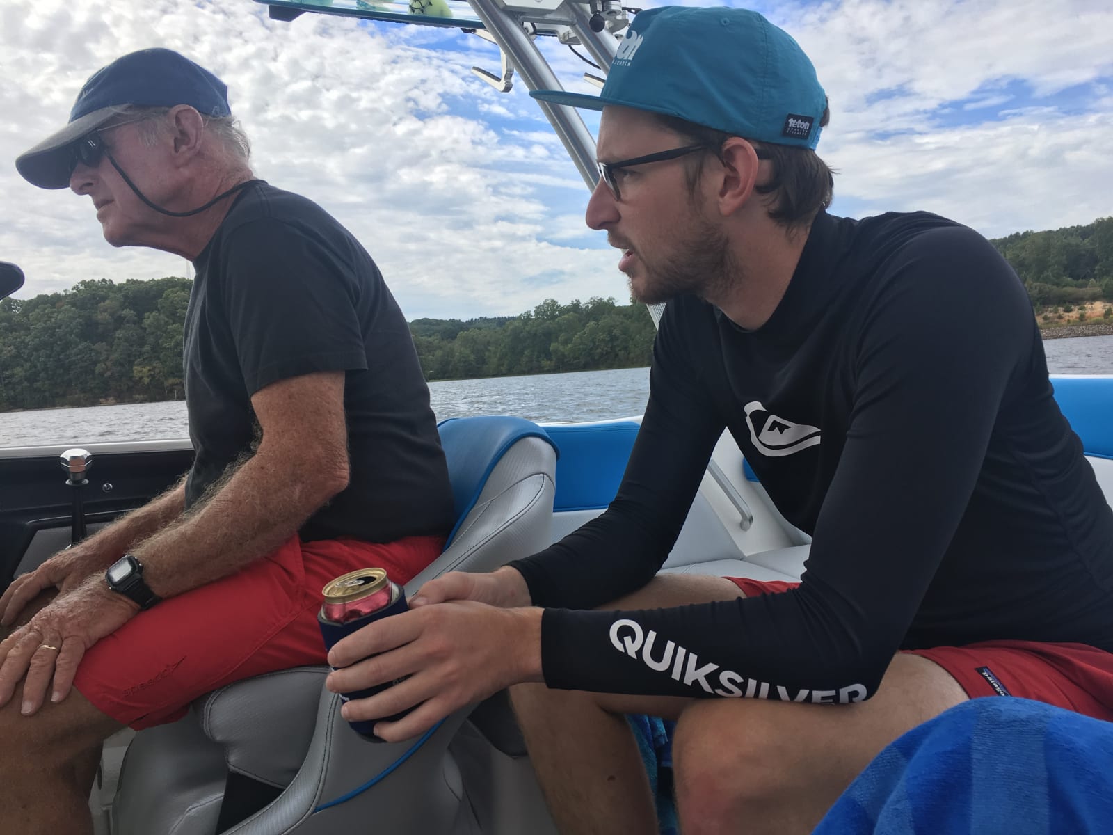 Two boat captains, father and son aboard the son's smaller boat on pickwick lake as part of a great loop journey.