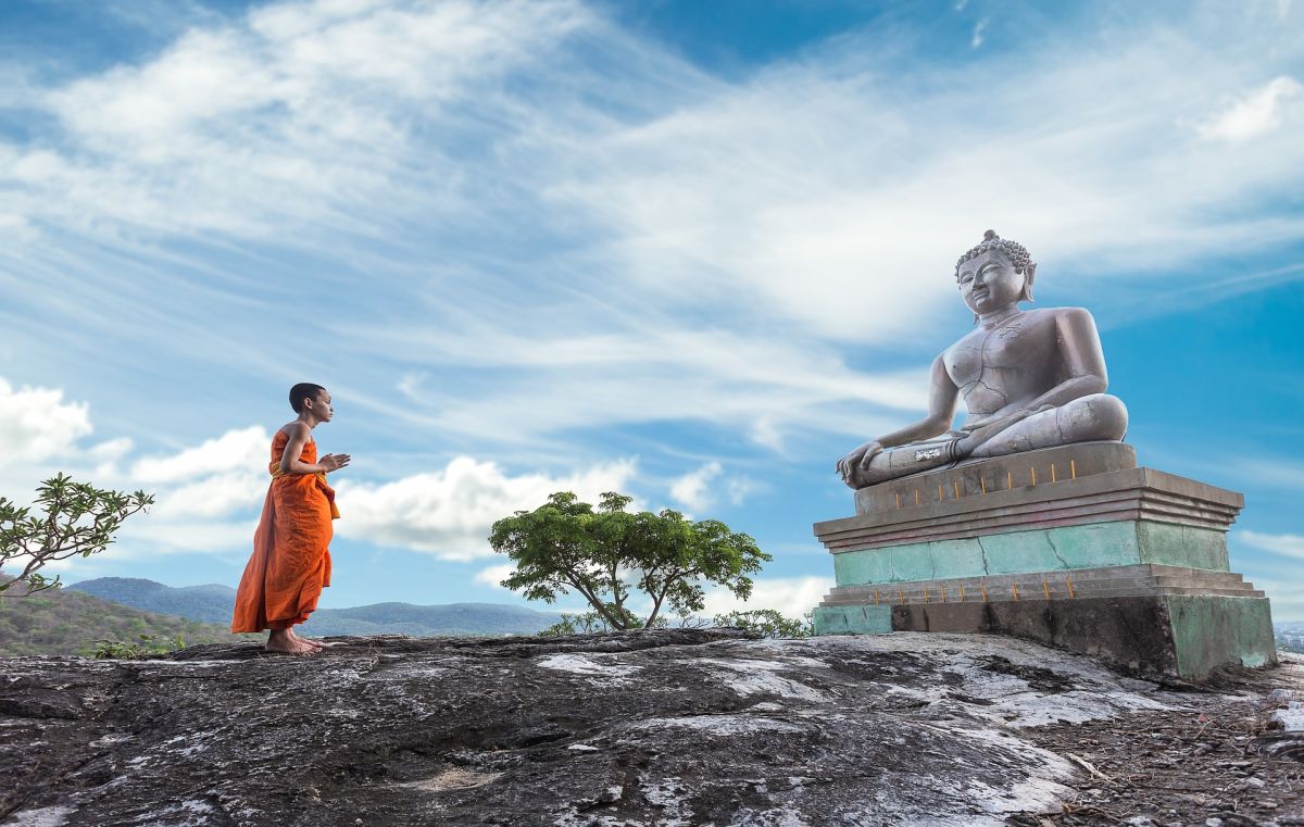 Buddha statue and young monk