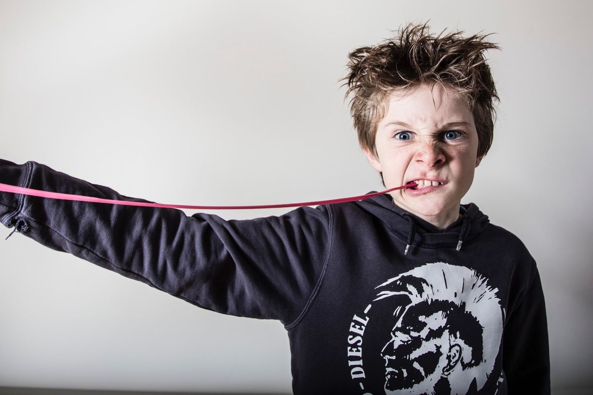 Boy chews sticky chewing gum