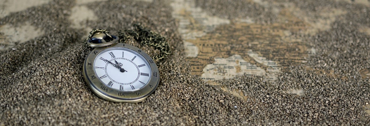 Pocket watch on sandy beach