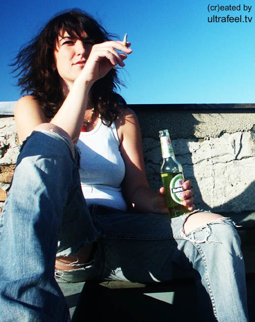 Woman drinking and smoking on rooftop