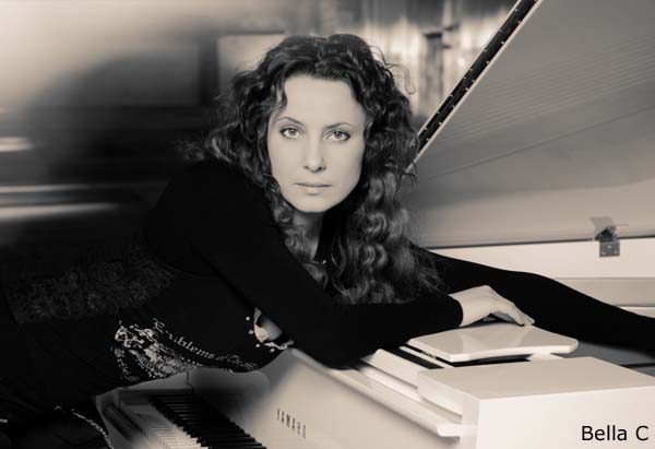 Bellla C, Singer and Piano Player in front of her instrument