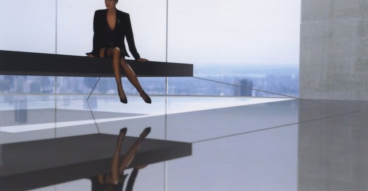 Magnetic floating bed: Woman sitting on it - by Janjaap-Ruijssenaars