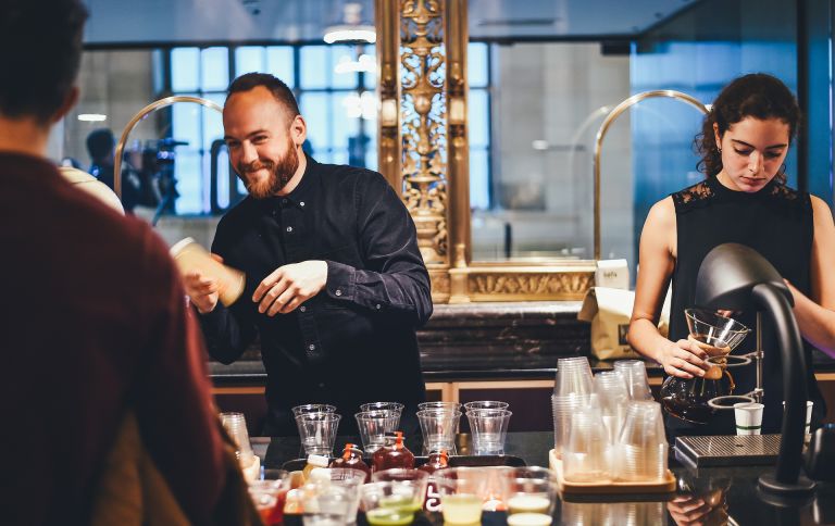 Bar: Woman and man serving beer and wine