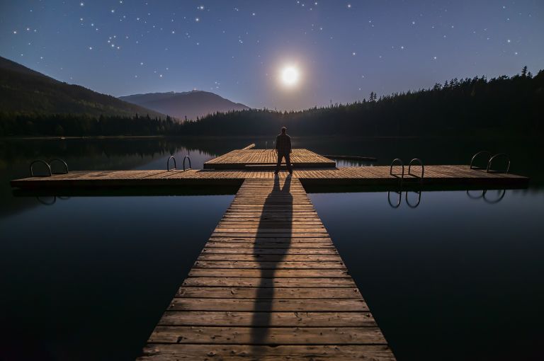 Mysterious man on a deck, pool. Dreamy, mystic.