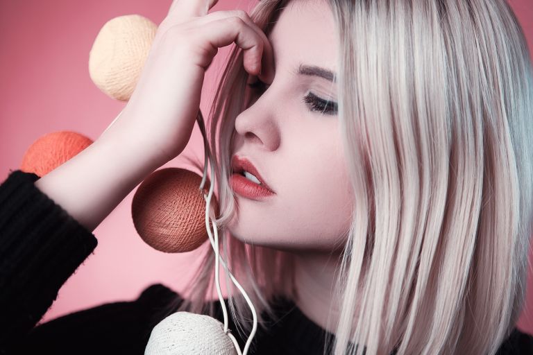 Blonde girl holding hair