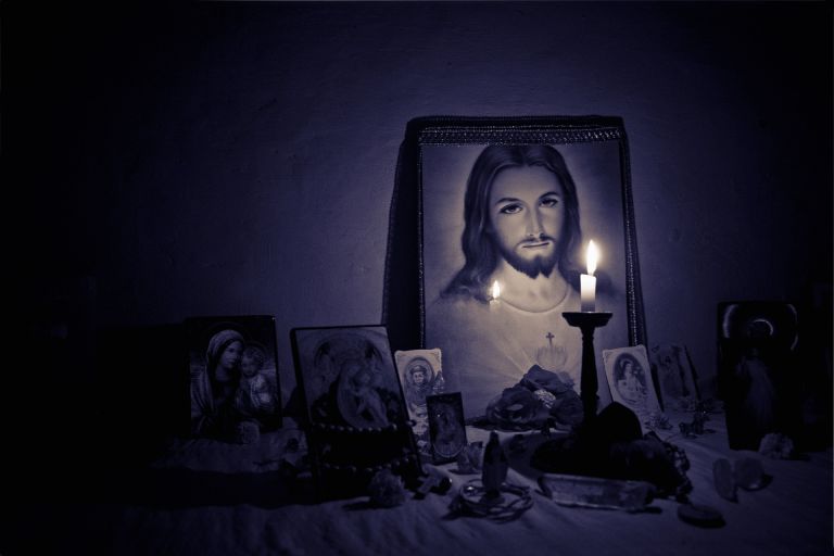 Jesus christ on a picture with candlelight