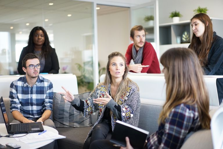 Communication in modern office: Men and women discussing