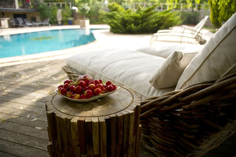 Sunbeds at pool with fruits