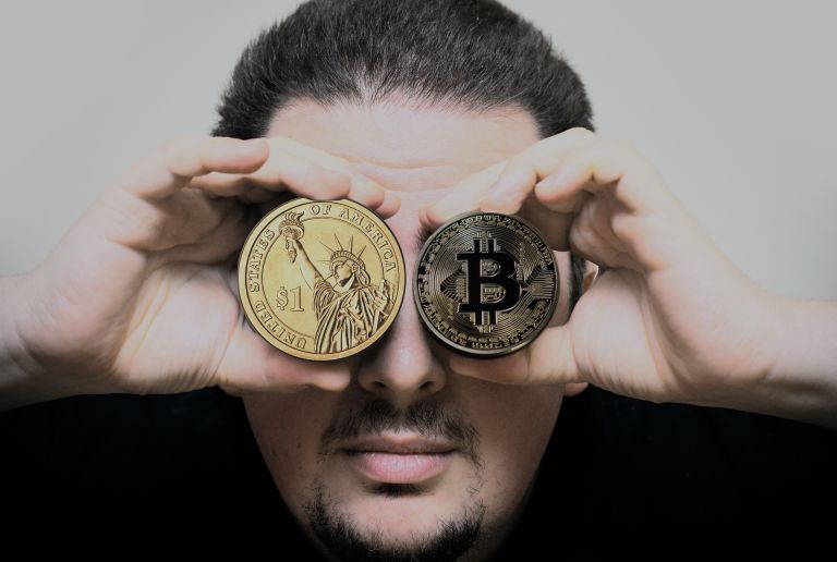 Man holding dollar, bitcoin, coin in eyes