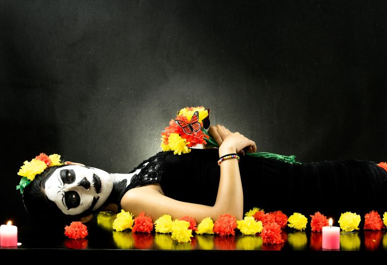 Women with white mask and flowers on day of death