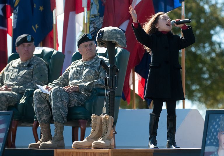 Rhema Marvanne, 7, sings "The Prayer" during a Remembrance Ceremony at Ft. Hood, TX, Nov. 5, 2010. The ceremony commemorated the lives of 13 people who died in a tragic shooting incident on the installation Nov. 5, 2009. Army photo by D. Myles Cullen (released)