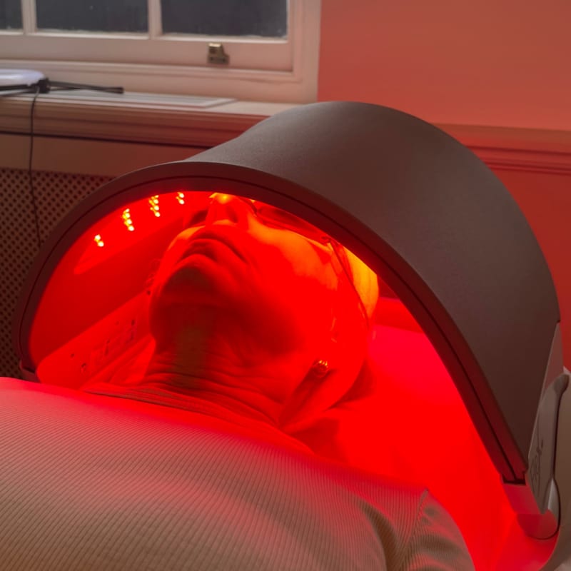 LED Therapy Woman on a bed with light helmet