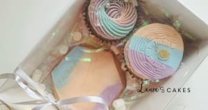 Celebration cake: A box of three decorated cookies in paste colors