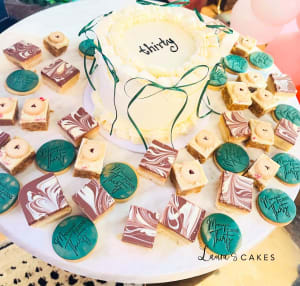 Celebration cake: A name on it and some cookies