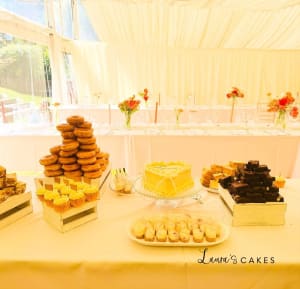 Wedding cake: A table with a bunch of pastries and pastries