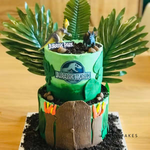 Celebration cake: A dinosaur on top of it
