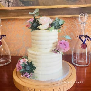 Wedding cake: A white cake with pink flowers on top