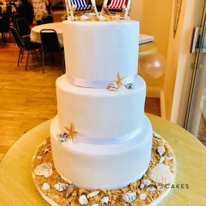 Wedding cake: A three tiered cake with a flag and shells