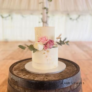 Wedding cake: A white cake with pink flowers on top