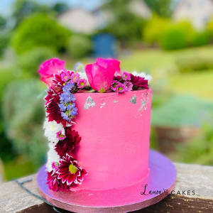 Celebration cake: A pink cake with flowers on top