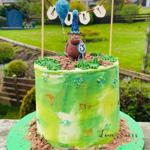 Celebration cake: A green frosting and a blue bird on top