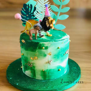 Celebration cake: A dinosaur on top of it