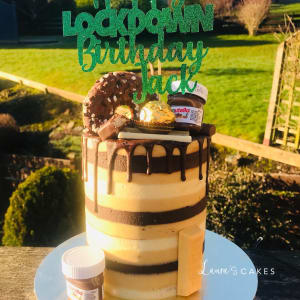 Celebration cake: A chocolate covered top and a green sign that says ' boo boo boo boo boo boo boo