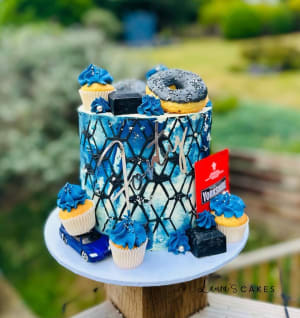Celebration cake: A blue and white cake with a bunch of cupcakes