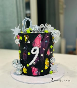 Celebration cake: A black cake with a number on top