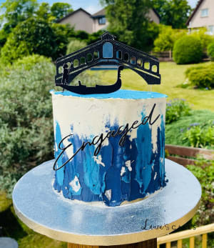 Celebration cake: A gun on top of it