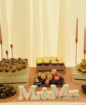 Wedding cake: A table with a number of cupcakes and a sign