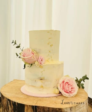 Wedding cake: A white cake with pink flowers on top