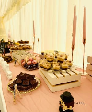 Wedding cake: A table with desserts and candles on it