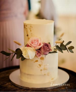 Wedding cake: A white cake with pink flowers on top