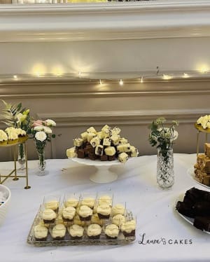 Wedding cake: A table with desserts and flowers on it